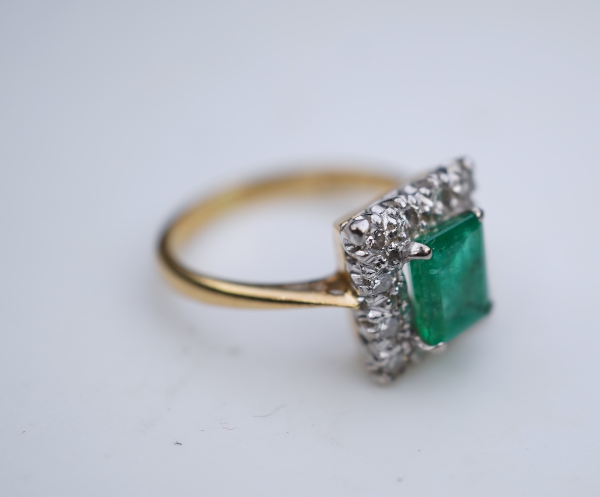 An emerald and diamond ring